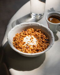Portion of gourmet granola and yogurt bowl breakfast