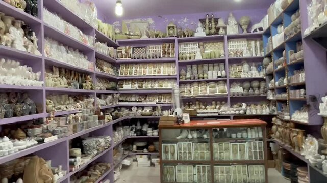 Lively boating point shopping street at Bhedaghat captured during a beautiful sunset, featuring local vendors, tourist activity, and scenic river charm.