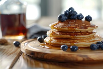 Vibrant Color Image of Stacked Blueberry Pancakes on Wooden Plate with Syrup