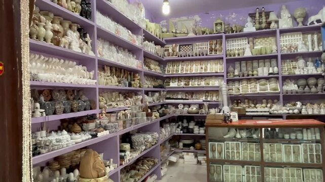 Lively boating point shopping street at Bhedaghat captured during a beautiful sunset, featuring local vendors, tourist activity, and scenic river charm.