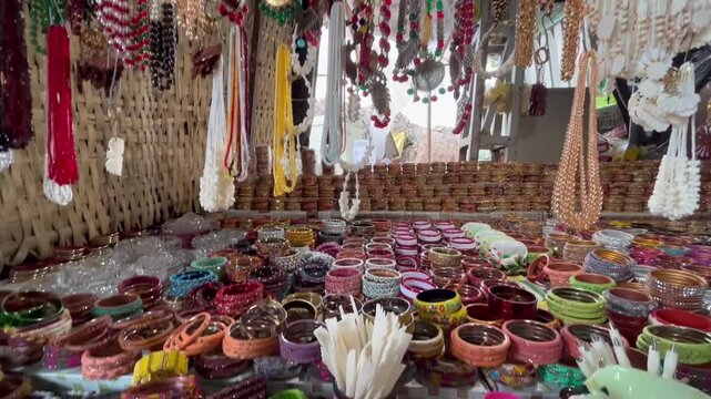 Lively boating point shopping street at Bhedaghat captured during a beautiful sunset, featuring local vendors, tourist activity, and scenic river charm.