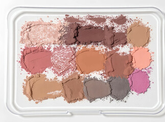 Smeared eyeshadow shades across a clear tray with no product in sight, only pigment


