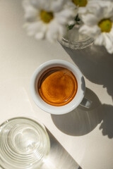 Top view on cup of espresso coffee with glass of water