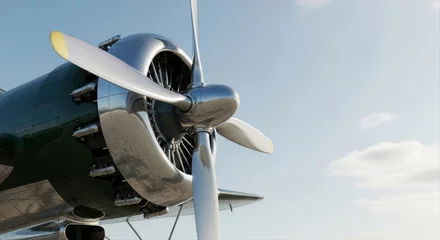 Papier peint photo Ancien avion Close up of a polished vintage propeller engine on a classic airplane against a blue sky.  © Meow Creations