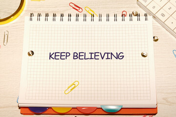 Business concept. Copy space. Concept Words KEEP BELIEVING, a motivational message written on a...