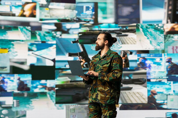 Officer monitoring real time combat data using advanced military systems, cyber tactics and digital...