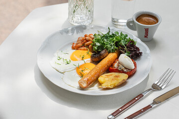 Portion of gourmet breakfast with sausage and fried eggs