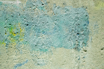 Randomly painted concrete wall as a backdrop for design work and more.