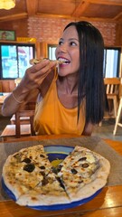 brunette woman eating pizza