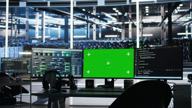 Chroma key computer displays in data center workplace used for managing supercomputers hardware energy consumption. Green screen PC used for automation in server hub workplace - Powered by Adobe