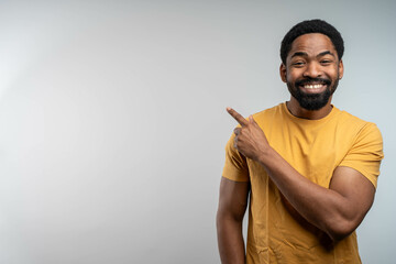 Photo of attractive guy hold hands finger direct up empty space excited good mood sales person wear...