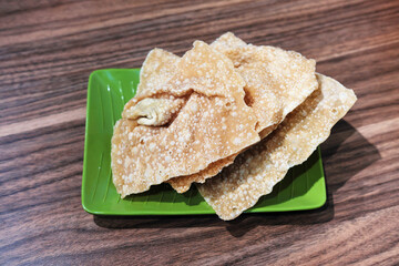 Crispy fried dumplings with meat filling, served on a green patterned plate