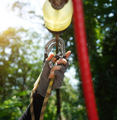 Woman is enjoying an exhilarating ride on a zip line that traverses the thick woods surrounding her