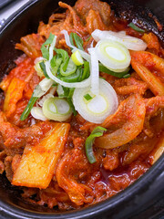 Spicy Kimchi Jjigae Stew in Black Bowl