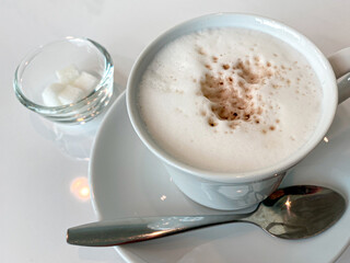 Cappuccino with Sugar Cubes on White Table