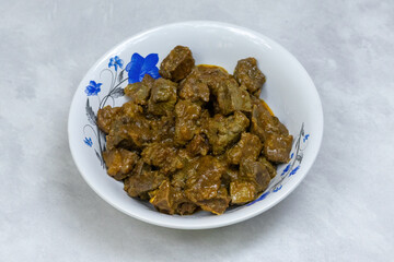 Tasty beef liver roast, Kolija Bhuna, served in a white bowl. Savory, healthy, and packed with essential vitamins.