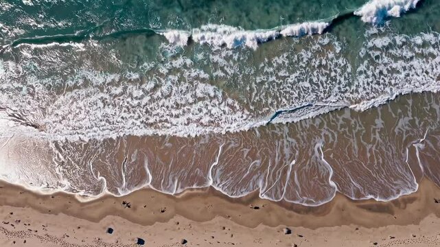 Waves crashing gently on sandy shore