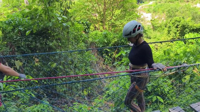 A man and a woman is enjoying an exhilarating ride on a zip line