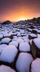Obraz premium Giants causeway winter sunset snow covered rocks