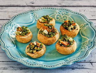 plate of stuffed mushrooms with spinach and goat cheese