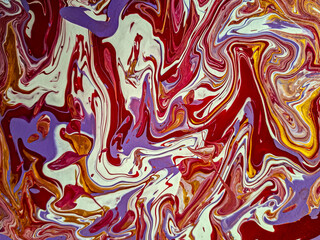 Swirling abstract pattern with vibrant red, purple, white, and yellow colors blending in dynamic...