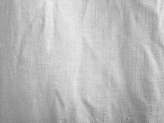Plain textured fabric with visible vertical and horizontal weaves creates a subtle, monochromatic pattern. Soft folds add depth and dimension to the otherwise uniform cloth surface