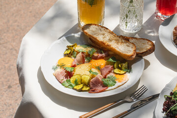 Gourmet portion of fried eggs and smoked meat breakfast