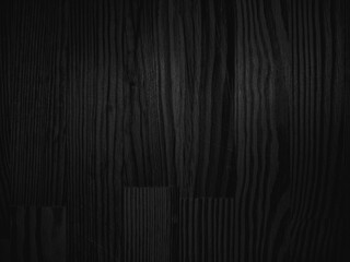 Dark wooden texture with distinct vertical grain patterns and subtle variations in shade, creating a rich and natural abstract appearance. No text is present in the image