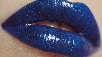 Glamorous Blue Lips: A close-up captures glossy, deep blue lips, showcasing their luscious texture and striking hue, a statement of beauty.