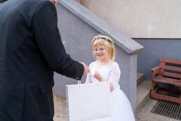 Girl receiving first communion gifts, smiling