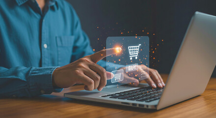 A person shopping online with a laptop and touching a virtual shopping cart icon on the screen