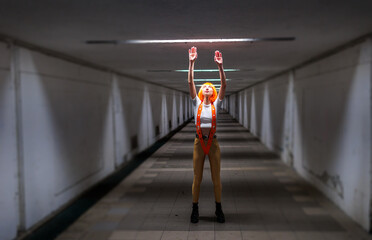 Obraz premium A beautiful woman with orange hair in a futuristic suit. Augmented reality game, future technologies, artificial intelligence concept.
