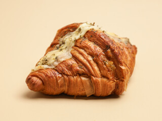 Freshly baked pastry with topping, on beige background