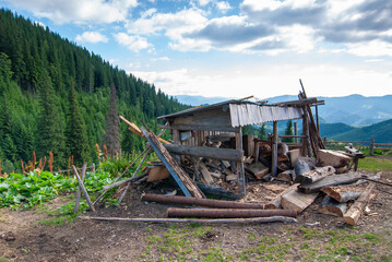 Woodpile shed in Carpathian mountains. Beautiful idyllic landscape
