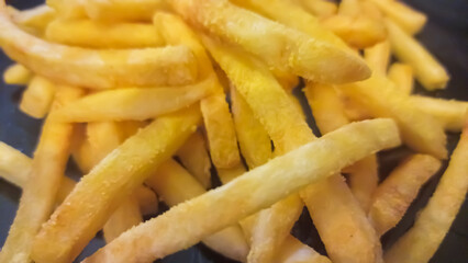 french fries on a black background