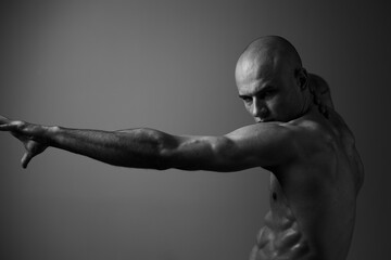 Powerful man posing in black and white, showcasing strength and determination in a dramatic...