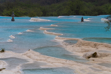 Huanglong National Park, blue water in limestone wells is a landmark for tourists to visit in Ngawa Tibetan and Qiang in Sichuan, China : June 18r 2024