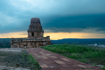 Ancient temple in Badami, Karnataka. The overcast sky adds intensity to the rugged terrain and the...