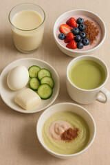 Balanced and nutritious breakfast spread with a variety of food items. Smoothie bowls, protein and light veggies for a healthy start.