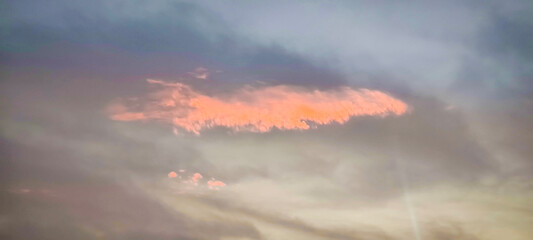 Fototapeta premium The sky and clouds are orange in the evening.