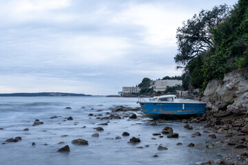 Boat at sunset, waves on the sea. High quality photo.