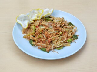 Gado-gado on plate, Indonesian typical food made from vegetables with peanut sauce with wooden...