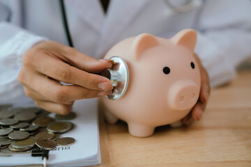 Doctor using stethoscope to examine a piggy bank, symbolizing the savings in medical care and...