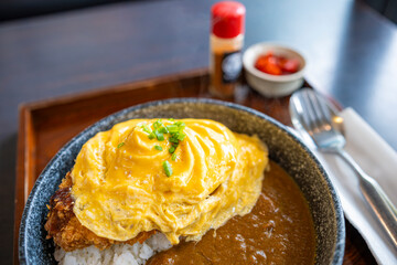 Pork curry rice with omelet.