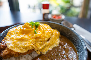 Pork curry rice with omelet.