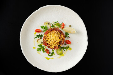 Gourmet Beef Tartare with Lemon and Herbs on White Plate