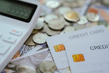 A person's hand holds a credit card over a laptop keyboard, indicating online shopping or payment...
