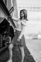 Black and white portrait of a young beautiful long-haired girl outdoors.