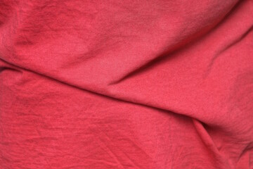 red texture from a piece of crumpled fabric on old clothes