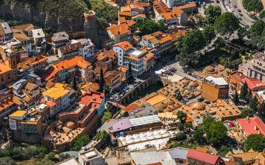 Aerial view of Abanotubani district in Tbilisi with terracotta rooftops and sulfur baths